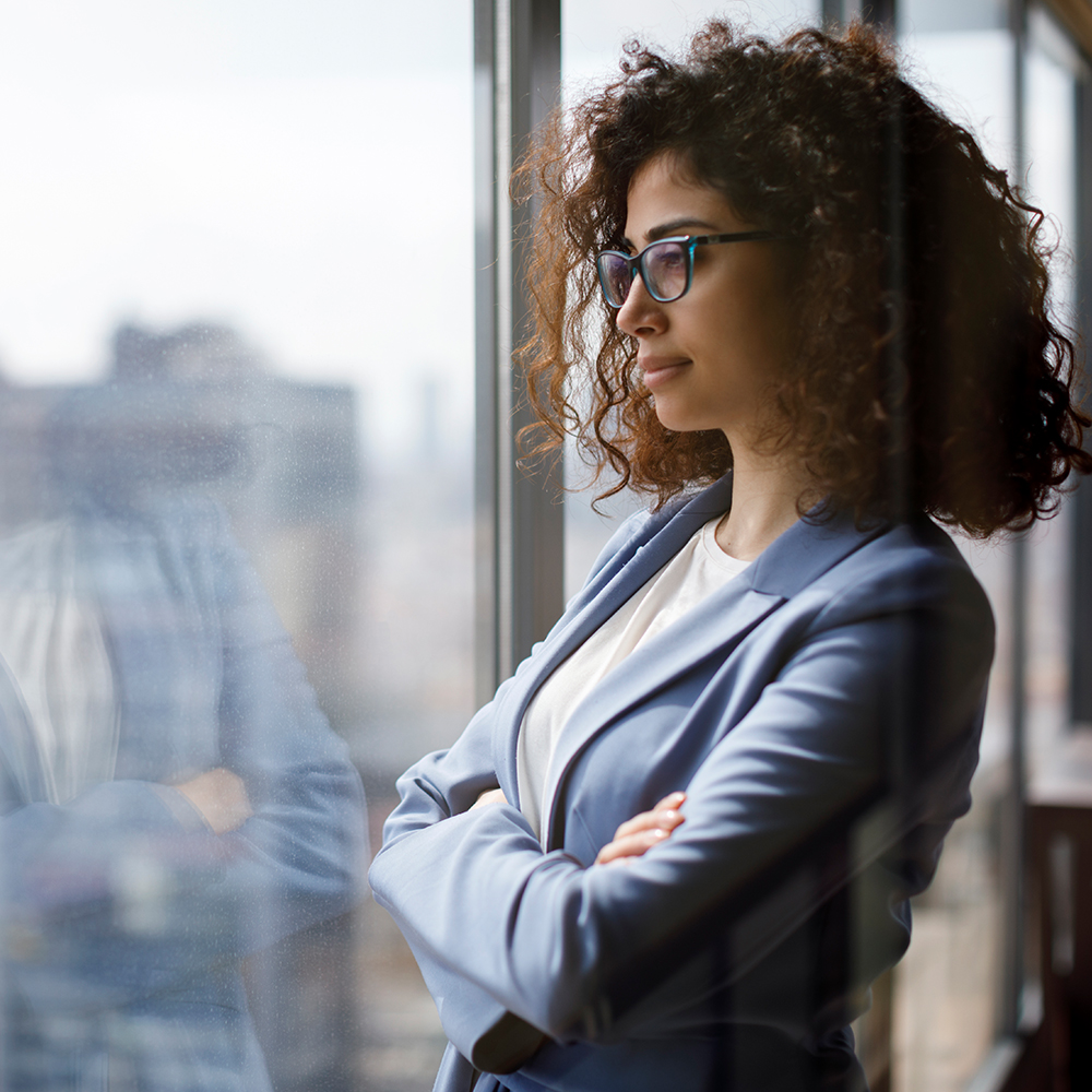 Woman gazing outside of a window