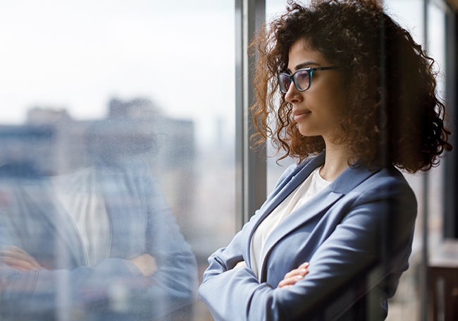 Woman gazing outside of a window